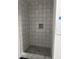 This shower features decorative tiles and a mosaic tile niche at 2148 N Pennsylvania St, Indianapolis, IN 46202