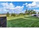 Vast, fenced-in backyard with lush green grass and mature trees, providing a secure and serene outdoor environment at 2211 Willowview Dr, Indianapolis, IN 46239