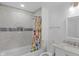 Bathroom featuring a tiled shower, white vanity with marble countertop, and updated fixtures at 2211 Willowview Dr, Indianapolis, IN 46239