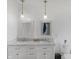 Bright bathroom featuring dual sinks, framed mirrors, marble countertops, and pendant lighting at 2211 Willowview Dr, Indianapolis, IN 46239