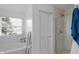 Modern bathroom with a soaking tub, glass-enclosed shower, and pristine white finishes at 2211 Willowview Dr, Indianapolis, IN 46239