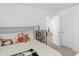 Bright bedroom with a cozy bed, bookshelf, and a view into another room at 2211 Willowview Dr, Indianapolis, IN 46239