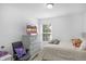Cozy bedroom featuring a bed, gray dresser with a TV, and a comfortable chair at 2211 Willowview Dr, Indianapolis, IN 46239