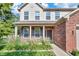 Close-up of the front entrance with brickwork, a dark-colored front door, and neatly arranged flower beds at 2211 Willowview Dr, Indianapolis, IN 46239