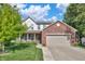 Two-story home featuring a brick facade, attached garage, and a well-maintained lawn with mature landscaping at 2211 Willowview Dr, Indianapolis, IN 46239