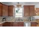 Functional kitchen featuring dark wood cabinets, stylish backsplash, and modern fixtures at 2211 Willowview Dr, Indianapolis, IN 46239