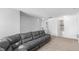 Bright living room with a gray sectional sofa, neutral carpet, and doorway to another room at 2211 Willowview Dr, Indianapolis, IN 46239