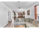Open-concept living room flows into kitchen featuring dark wood cabinets and a wooden dining table at 2211 Willowview Dr, Indianapolis, IN 46239
