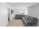 Cozy living room with plush, oversized sectional sofa, neutral carpet, and natural light from the window at 2211 Willowview Dr, Indianapolis, IN 46239
