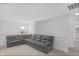 Spacious living room with a large sectional sofa, neutral carpet, and a window at 2211 Willowview Dr, Indianapolis, IN 46239