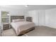 Comfortable bedroom with wooden bed frame, soft lighting, and a peaceful, inviting feel at 2211 Willowview Dr, Indianapolis, IN 46239