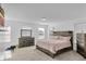 Spacious main bedroom boasts a rustic wood bed frame, matching dressers, and lots of natural light at 2211 Willowview Dr, Indianapolis, IN 46239