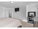 Bright bedroom features a desk, a rustic dresser, and a mounted TV for relaxing at 2211 Willowview Dr, Indianapolis, IN 46239
