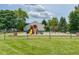 Community playground with slides, swings, and lush green surroundings at 2211 Willowview Dr, Indianapolis, IN 46239