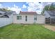 Home's backyard featuring green grass, a white fence, and the exterior of the home at 2309 Maple St, Columbus, IN 47201