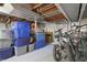 Basement with exposed ceiling, containing bicycles and multiple storage containers at 2309 Maple St, Columbus, IN 47201