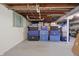 Open basement with storage containers and exposed wooden rafters at 2309 Maple St, Columbus, IN 47201