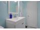 Bright bathroom features a white vanity with sink, mirrored cabinet, and neutral accessories at 2309 Maple St, Columbus, IN 47201