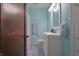 Bright bathroom with blue walls, white vanity, patterned shower curtain, and coordinated towel accents at 2309 Maple St, Columbus, IN 47201