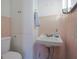Tiled bathroom featuring a white sink, cabinet, and matching tiled walls at 2309 Maple St, Columbus, IN 47201