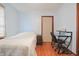 Light-filled bedroom with hardwood floors, featuring a bed and a desk area perfect for work at 2309 Maple St, Columbus, IN 47201