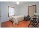 Cozy bedroom with a light blue color scheme with wood floors and a window for natural light at 2309 Maple St, Columbus, IN 47201