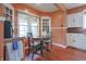 Bright dining area with hardwood floors, vintage cabinets, and a view of the well-maintained landscaping at 2309 Maple St, Columbus, IN 47201