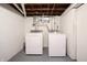 Bright laundry room with open ceiling, featuring modern washer and dryer units at 2309 Maple St, Columbus, IN 47201