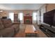 Bright living room with a cozy fireplace, large windows and comfortable furnishings at 2309 Maple St, Columbus, IN 47201