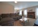 Spacious living room with a fireplace, large windows, and a comfortable seating area at 2309 Maple St, Columbus, IN 47201