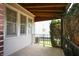 Charming porch with iron railings, a wood ceiling, and view of the well-maintained front yard and landscaping at 2309 Maple St, Columbus, IN 47201