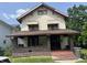 A two-story home with a covered front porch and awnings over the windows at 24 Hendricks Pl, Indianapolis, IN 46201