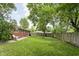 Backyard featuring a wood fence providing privacy, grassy area and shade trees at 258 N Green Springs Rd, Indianapolis, IN 46214