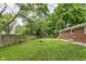 Backyard featuring a wood fence providing privacy, grassy area and shade trees at 258 N Green Springs Rd, Indianapolis, IN 46214