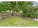 Backyard features a wood fence providing privacy, grassy area and shade trees at 258 N Green Springs Rd, Indianapolis, IN 46214