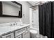 Bathroom featuring a shower-tub combo with shower curtain, toilet and marble vanity at 258 N Green Springs Rd, Indianapolis, IN 46214