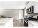 Open kitchen area with a center island, microwave, stove, and breakfast bar at 258 N Green Springs Rd, Indianapolis, IN 46214