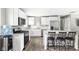Bright kitchen with white cabinets, stainless steel appliances, and a breakfast bar at 258 N Green Springs Rd, Indianapolis, IN 46214