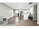 Open-concept kitchen and dining area with laminate floors, white cabinets, and stainless steel appliances at 258 N Green Springs Rd, Indianapolis, IN 46214