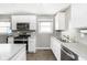 Modern kitchen featuring stainless steel appliances, a double sink, and light gray countertops at 258 N Green Springs Rd, Indianapolis, IN 46214