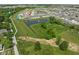 A scenic aerial view captures the neighborhood's pond, gardens, and surrounding green spaces at 2892 Maricopa Blvd, Whitestown, IN 46075