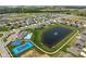 Aerial view of a community with houses, ponds, a pool, a tennis court, and green spaces at 2892 Maricopa Blvd, Whitestown, IN 46075