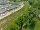 Aerial view of a residential area with a trail, pond and newly built homes at 2892 Maricopa Blvd, Whitestown, IN 46075