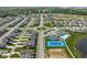 An aerial view displays community pool, tennis court, and green spaces within the neighborhood at 2892 Maricopa Blvd, Whitestown, IN 46075