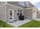 Gray and brick townhouse with a grill on the concrete patio and a door leading to the backyard at 2892 Maricopa Blvd, Whitestown, IN 46075