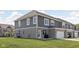 A gray and brick townhouse features a well-manicured backyard and lawn, complete with a covered grill at 2892 Maricopa Blvd, Whitestown, IN 46075