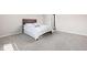 Clean bedroom with neutral carpet, a queen size bed with linens, and a door at 2892 Maricopa Blvd, Whitestown, IN 46075
