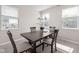 Cozy dining room features a wooden table, four chairs, a chandelier, and bright natural lighting at 2892 Maricopa Blvd, Whitestown, IN 46075