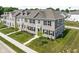 Charming townhome showcasing beautiful brickwork, manicured lawn, and inviting balcony at 2892 Maricopa Blvd, Whitestown, IN 46075