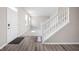 Bright foyer with wood-look flooring, a staircase, and a view into the adjacent room at 2892 Maricopa Blvd, Whitestown, IN 46075